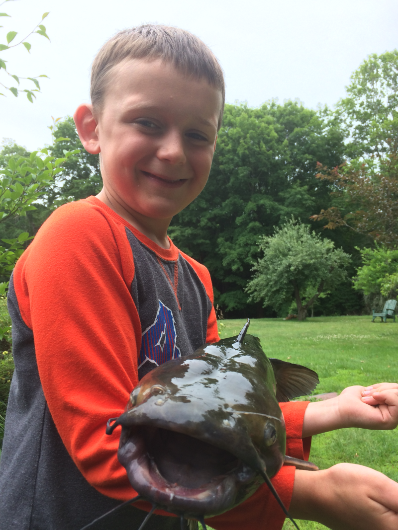 Boy with a large channel catfish.