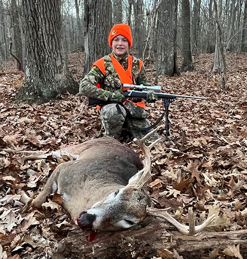 Junior deer hunter with a first deer.