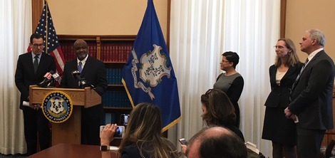 Justice Robinson speaking at podium